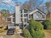 Charming two-story home featuring a wood facade, multi-level deck, and attached two-car garage at 2541 Deer Isle Cv, Lawrenceville, GA 30044