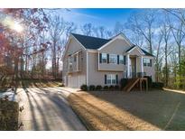 Charming two-story home featuring a two-car garage and manicured front lawn at 8885 Camp Tree Ct, Winston, GA 30187