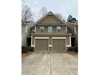 Inviting two-story home with a double garage and neutral-colored siding at 256 Oakview Dr, Canton, GA 30114