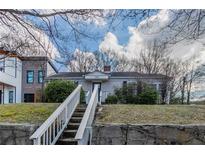 Charming single-story home featuring a stone foundation, grassy yard and inviting walkway at 1340 Bernard Nw St, Atlanta, GA 30314
