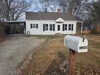 Charming one-story home with gray siding, black shutters, and a well-manicured front yard at 3706 College Ave, Clarkston, GA 30021