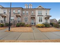 Charming townhome exterior with brick facade, dormer windows, and well-maintained landscaping at 2051 Glenview Park Cir, Duluth, GA 30097