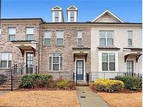 Charming townhome exterior with brick facade, small front yard, and inviting entrance at 2051 Glenview Park Cir, Duluth, GA 30097