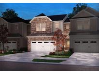 Charming two-story home features a stone facade, three-car garage, and beautifully landscaped front yard at 4179 Waratah Way, Mableton, GA 30126