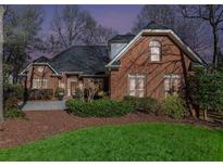 Charming brick home with manicured lawn, mature trees and inviting entrance at 4051 Ridgehurst Se Dr, Smyrna, GA 30080