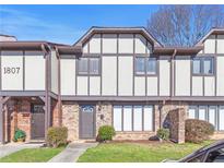 Charming townhome features traditional architecture with brick and siding accents at 1807 Ashborough Cir # G, Marietta, GA 30067