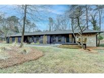 Stunning ranch-style home boasts a modern design with a stone accent wall and beautiful landscaping at 3542 Briarcliff Ne Rd, Atlanta, GA 30345