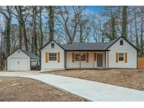 Charming renovated single-story home with a detached garage and inviting front porch at 500 Pomona Sw Cir, Atlanta, GA 30315