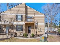 Charming two-story home with a balcony and manicured front yard at 1391 Old Coach Sw Rd, Marietta, GA 30008