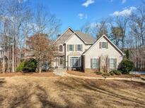 Charming two-story home with stone accents and a well-maintained front yard, perfect for curb appeal at 210 Lawn Market, Sharpsburg, GA 30277