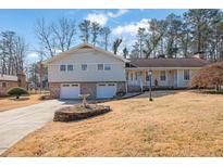 Charming two-story home featuring an attached two-car garage and a well-maintained front yard at 2864 Saint Andrews Ne Way, Marietta, GA 30062