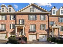 Charming red brick townhome with black shutters, a well-kept front yard, and a welcoming entrance at 3707 Peachtree Ne Rd # 8, Atlanta, GA 30319