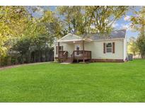Charming home featuring a well-manicured lawn and inviting front porch at 2458 Calvin Ave, East Point, GA 30344