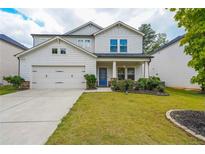 Charming two-story home with white siding, well-manicured lawn, and a cozy front porch at 1935 Azure Grove Ct, Marietta, GA 30008