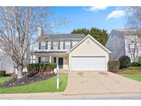 Charming two-story home with manicured lawn, a two-car garage, and inviting curb appeal at 79 Greystone Way, Hiram, GA 30141