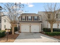 Two-story townhome with a two-car garage and well-manicured landscaping at 247 Cavendar Way # 17, Marietta, GA 30066