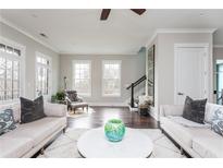 Bright living room with hardwood floors, neutral decor, and large windows at 16 Ramsey St, Roswell, GA 30075