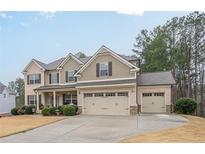 Charming two-story home with brick and siding exterior and a three-car garage at 1050 Silver Thorne Dr, Loganville, GA 30052