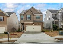 Two-story home with a two-car garage and a well-maintained front yard at 5152 Rapahoe Trl, Atlanta, GA 30349