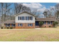 Charming two-story brick home with blue shutters and a well-manicured lawn at 2270 Old Concord Se Dr, Covington, GA 30016
