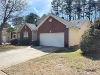 Traditional home with brick and siding, featuring an attached two-car garage and well-maintained landscaping at 396 Avian Forest Dr, Stockbridge, GA 30281