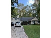 Charming single-story home with a well-manicured front lawn and a two-car garage at 5830 Briar Ct, Cumming, GA 30028