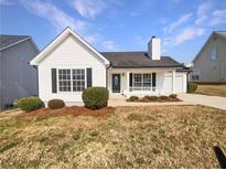 Charming single-story home with tidy landscaping, black shutters, and a cozy front porch at 6782 Gina Agha Cir, Lithonia, GA 30038