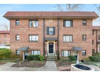 Charming brick apartment building featuring a red tile roof and striped awnings at 323 3Rd Ne St # 5, Atlanta, GA 30308