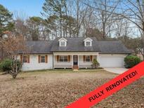 Charming, fully renovated, one-story home featuring a welcoming front porch and attached two-car garage at 1010 James Madison Ct, Mcdonough, GA 30253