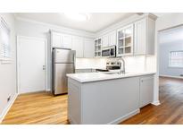 Modern kitchen features stainless steel appliances, white cabinets, and quartz countertops at 430 Lindbergh Ne Dr # M1, Atlanta, GA 30305