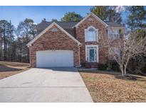 Charming brick two-story home with attached garage and well-manicured front lawn at 849 Kirsten Jane Ct, Lawrenceville, GA 30045