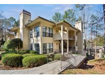 Inviting condo complex with landscaped grounds, showcasing a well-maintained facade and walkway at 310 Comeragh Se, Smyrna, GA 30080