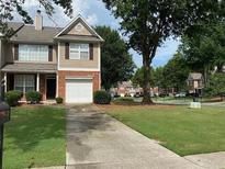 Inviting two-story home featuring a well-manicured lawn and a charming brick facade at 164 Haven Oak Way, Lawrenceville, GA 30044