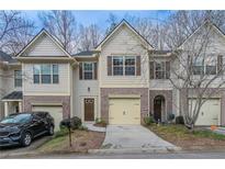 Charming townhome with brick accents, an attached garage, and a welcoming front entrance at 2890 Ridgeview Sw Dr, Atlanta, GA 30331