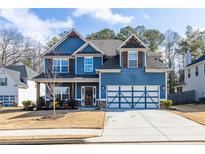 Charming two-story home with a well-manicured lawn and a two-car garage at 117 Pacific Ave, Sharpsburg, GA 30277