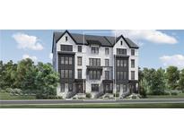 Beautiful three-story townhome with brick and stucco facade, black trim and a modern design at 3462 Dryden Se Ln, Vinings, GA 30339