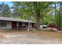 Charming single-story home with well-manicured lawn and mature trees in a serene setting at 4033 Louise St, Powder Springs, GA 30127