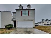 Charming home featuring a two-car garage, dormer windows, and a well-maintained front lawn at 1211 Brookstone Rd, Atlanta, GA 30349