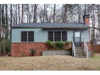 Charming single-story home with a brick foundation and well-lit entrance at 592 Alpine Way, Marietta, GA 30062