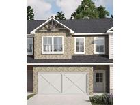 Charming two-story home with stone exterior, attached garage, and well-maintained landscaping at 958 Elwood St, Dacula, GA 30019