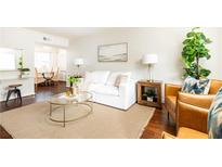 Cozy living room featuring a white sofa, brown leather chairs and a glass coffee table at 100 Biscayne Nw Dr # 4, Atlanta, GA 30309