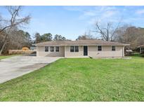 Charming ranch-style home with a well-maintained lawn and a spacious driveway at 57 Pierce Rd, Hiram, GA 30141