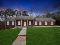 Charming single-story brick home featuring a well-manicured lawn and a classic design at 3113 Melissa Ct, Douglasville, GA 30135