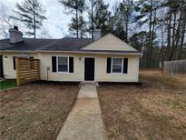 Charming home featuring black door and shutters and yellow siding at 104 Westland Sw Ct, Marietta, GA 30064