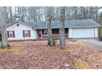 Charming one-story home featuring a brick facade and a two-car garage at 11006 Clearwater Dr, Hampton, GA 30228