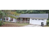 Charming one-story home with brick accents, white siding, and attached two-car garage at 11006 Clearwater Dr, Hampton, GA 30228