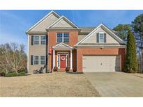 Exterior elevation showing a 2-story brick and tan home with an attached 2-car garage at 5305 Redfield Way, Cumming, GA 30028