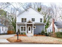 Charming two-story home with a welcoming front porch and attractive gray and white exterior at 1467 Lockwood Sw Dr, Atlanta, GA 30311