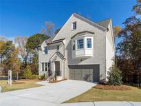 Beautiful two-story home with light brick, bay window, two-car garage, and well-manicured lawn at 3909 Enclave Way, Tucker, GA 30084