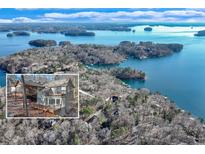 Breathtaking aerial view of lakefront home nestled among trees with lake and islands in the background at 7875 Robin Rd, Cumming, GA 30041
